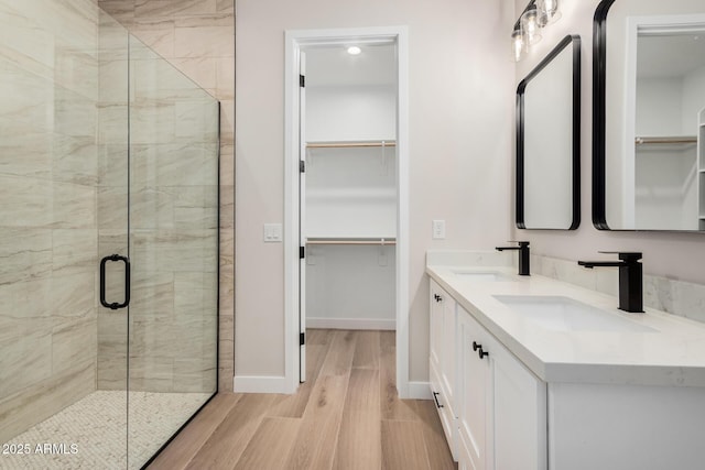 bathroom featuring vanity, an enclosed shower, and hardwood / wood-style floors