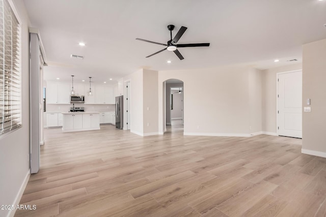 unfurnished living room featuring light wood-type flooring and ceiling fan