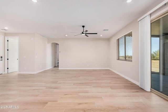 unfurnished room with ceiling fan and light hardwood / wood-style floors