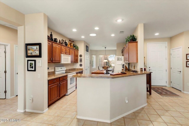 kitchen with decorative light fixtures, recessed lighting, visible vents, light tile patterned flooring, and white appliances