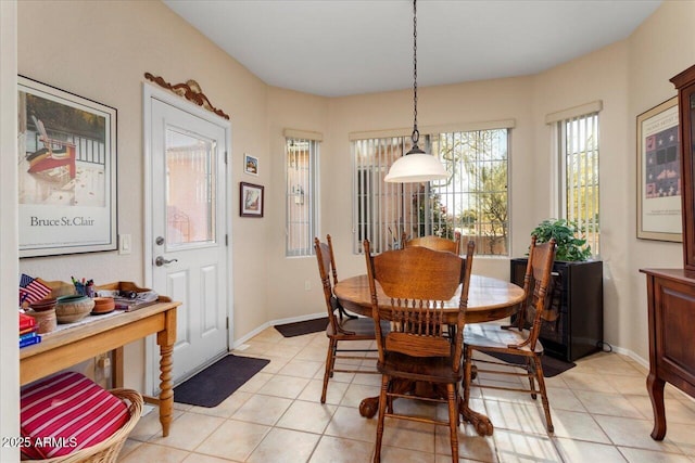 dining room with light tile patterned flooring and baseboards