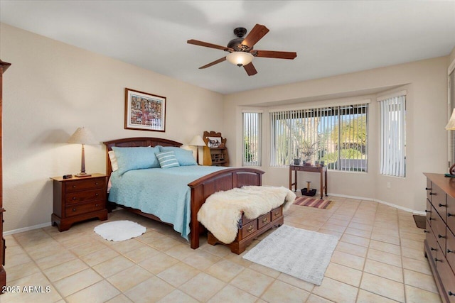 bedroom featuring light tile patterned floors, ceiling fan, and baseboards