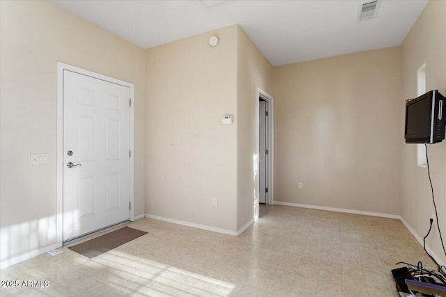 interior space with light floors, visible vents, and baseboards