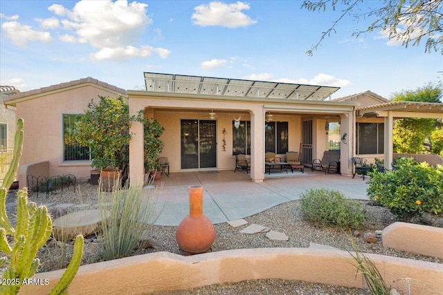 back of house with a patio area and stucco siding