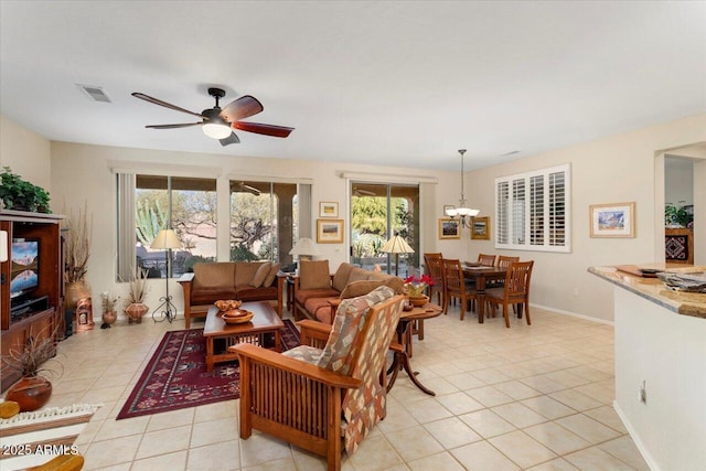 tiled living room featuring ceiling fan and plenty of natural light