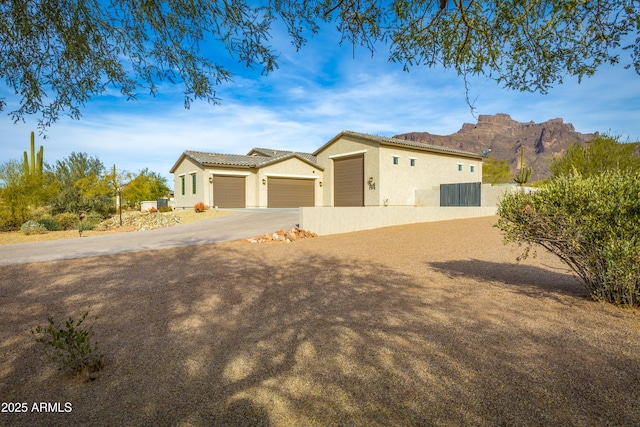 view of front facade with a mountain view and a garage