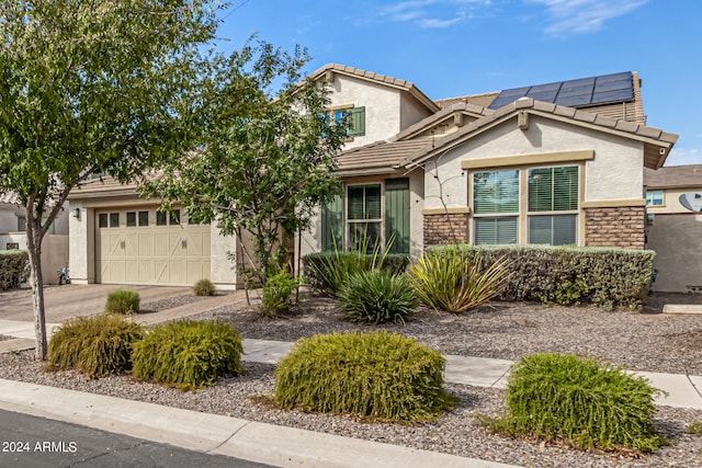 view of front of house featuring a garage and solar panels