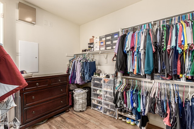 spacious closet with light hardwood / wood-style floors