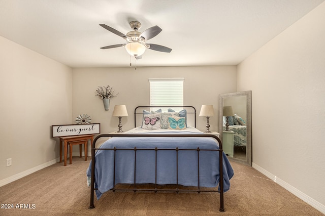 bedroom featuring ceiling fan and light carpet