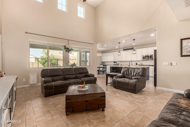 tiled living room featuring a high ceiling