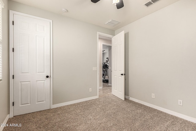 unfurnished bedroom with light carpet and ceiling fan