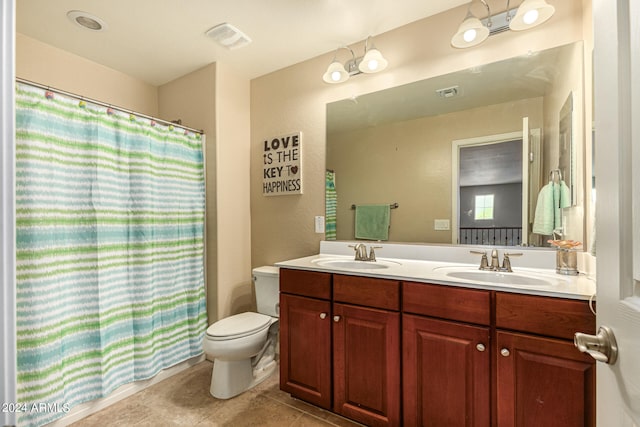 bathroom featuring tile patterned floors, vanity, walk in shower, and toilet