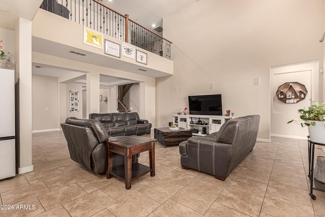 living room featuring a high ceiling and light tile patterned floors