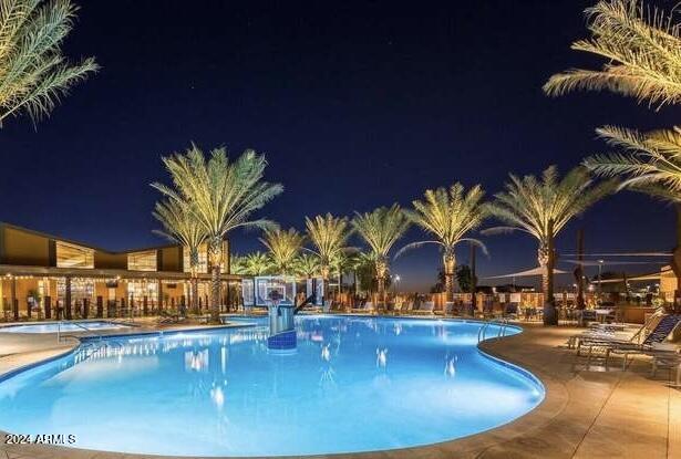 pool at twilight with a patio