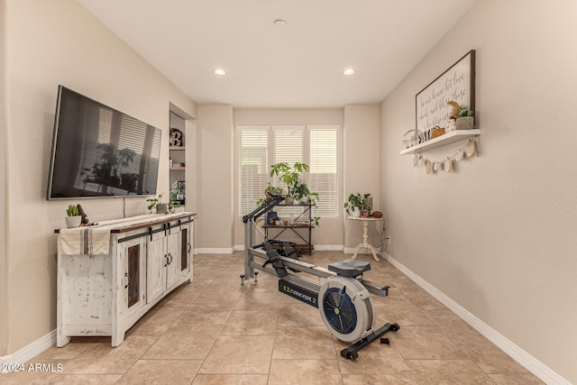 exercise room with light tile patterned floors