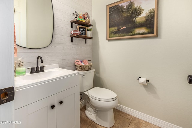 bathroom featuring tile patterned floors, vanity, and toilet