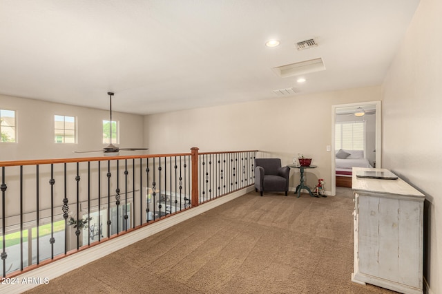 sitting room featuring a wealth of natural light and carpet flooring