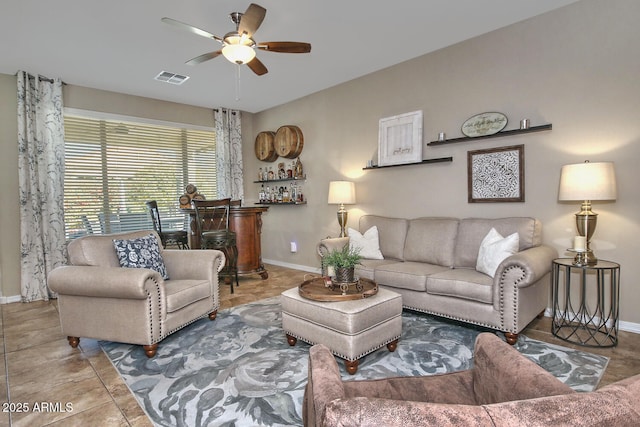 tiled living room featuring ceiling fan