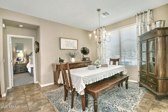 tiled dining space featuring a notable chandelier