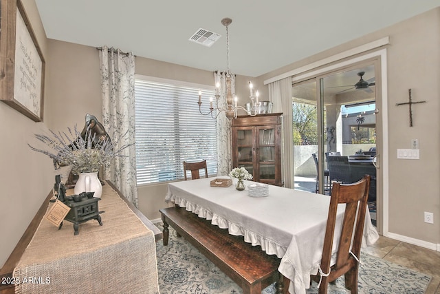 dining area featuring ceiling fan with notable chandelier and tile patterned floors