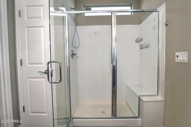 bathroom featuring a shower with shower door