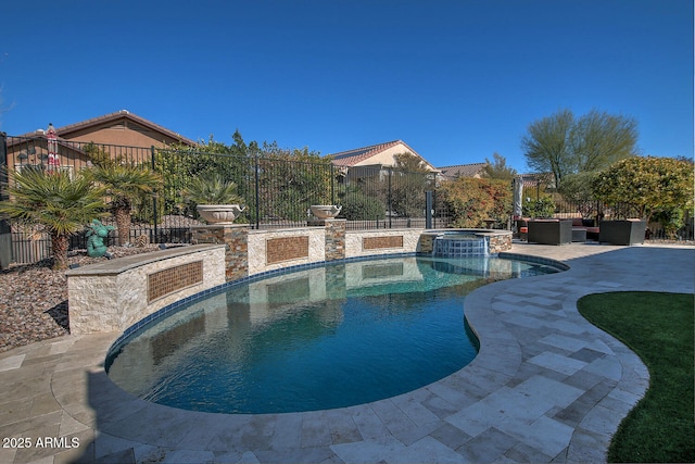 view of pool with an in ground hot tub and a patio