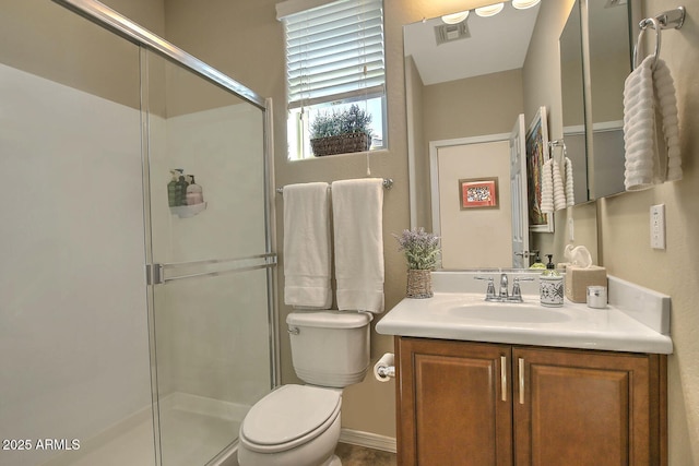 bathroom featuring an enclosed shower, vanity, and toilet