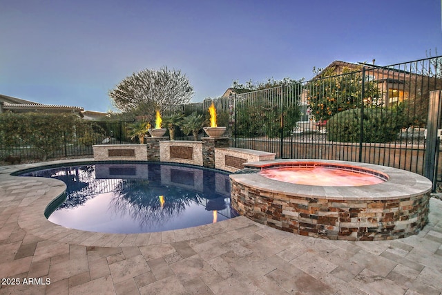 view of swimming pool featuring a patio and an in ground hot tub