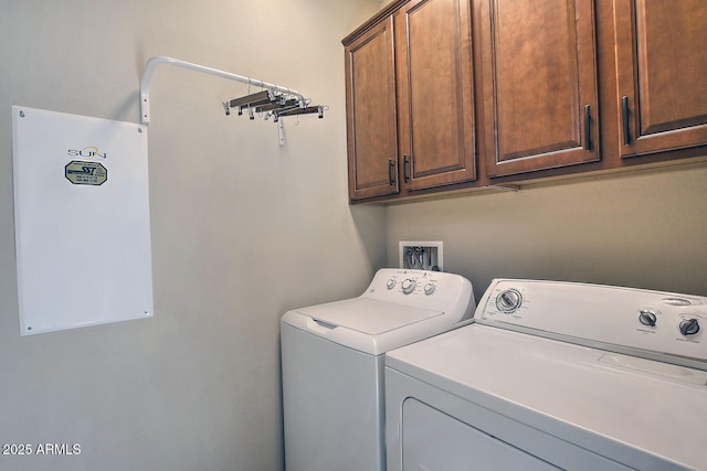 clothes washing area with cabinets and independent washer and dryer