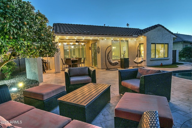 patio terrace at dusk featuring outdoor lounge area