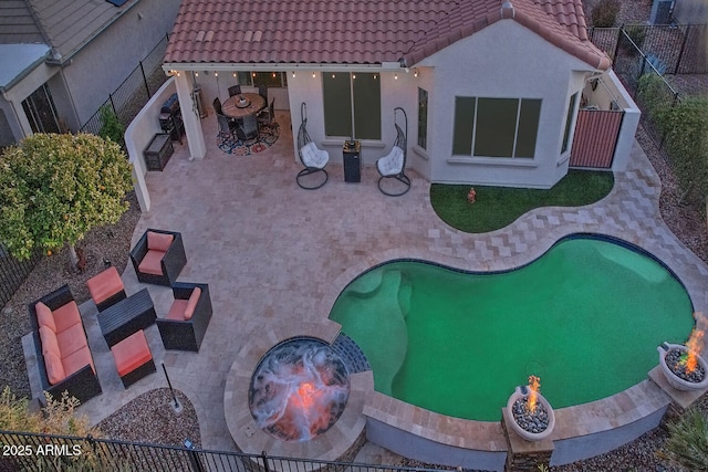 view of swimming pool with a patio area and a fire pit