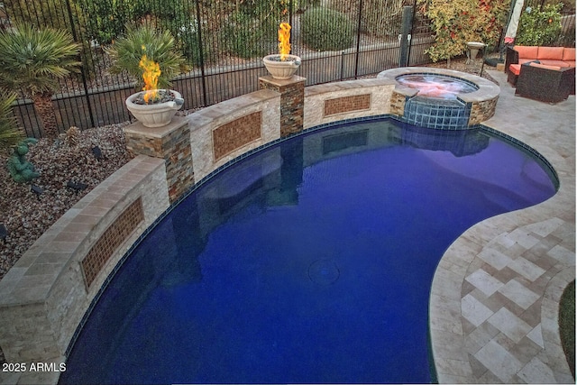 view of swimming pool featuring an in ground hot tub