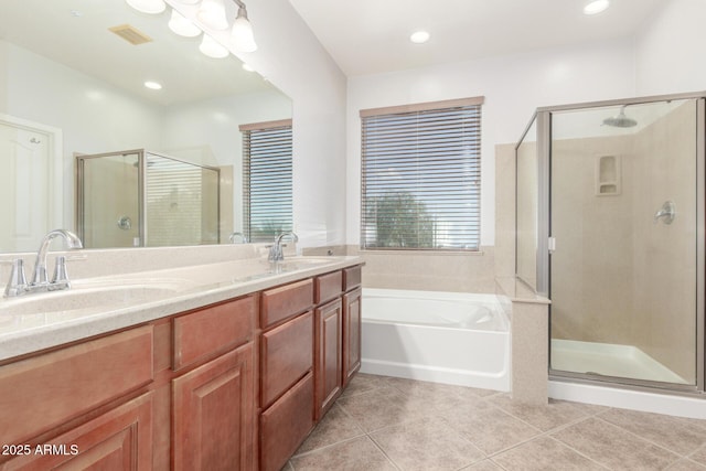 full bathroom featuring a bath, a sink, a stall shower, and tile patterned flooring
