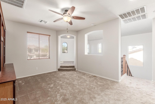 entryway featuring visible vents, arched walkways, and a ceiling fan
