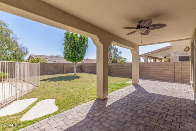 view of patio with a fenced backyard and ceiling fan