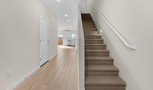 stairway with hardwood / wood-style flooring