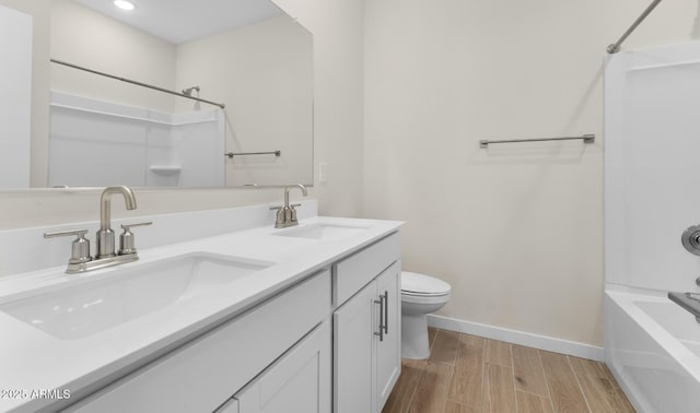 full bathroom with shower / bath combination, vanity, hardwood / wood-style floors, and toilet