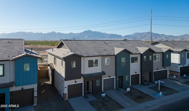 view of front of home with a mountain view and a garage