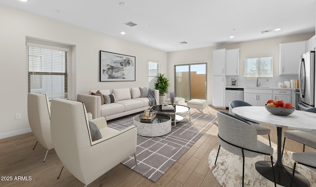 living room featuring sink and light wood-type flooring