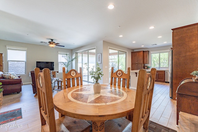 dining space featuring light hardwood / wood-style flooring and ceiling fan