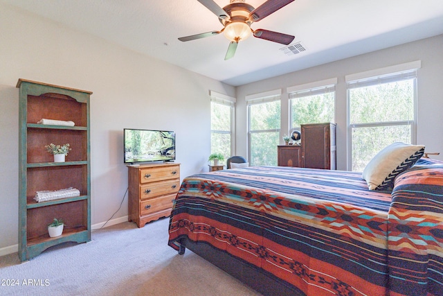 bedroom featuring baseboards, a ceiling fan, visible vents, and carpet