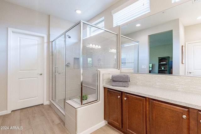 bathroom featuring a shower stall, tasteful backsplash, wood finished floors, and recessed lighting