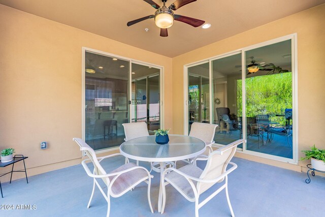 view of patio featuring outdoor dining area and ceiling fan