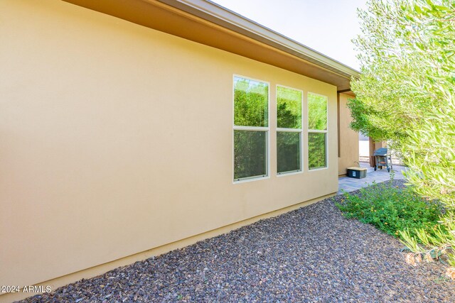 view of property exterior with a patio area