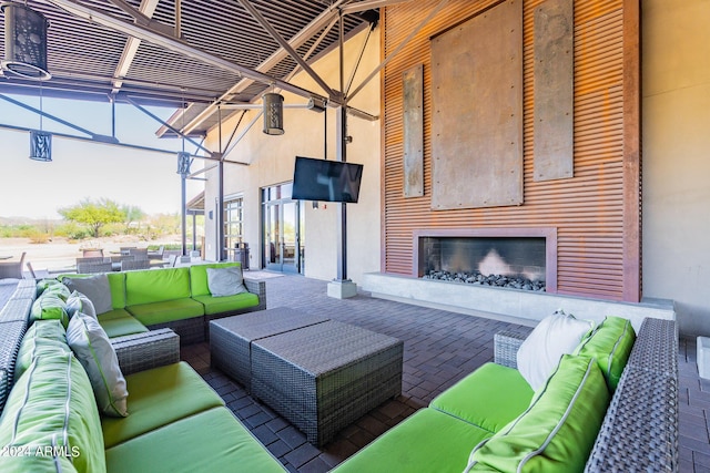 view of patio with an outdoor living space with a fireplace