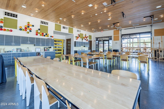 dining space featuring wood ceiling and sink