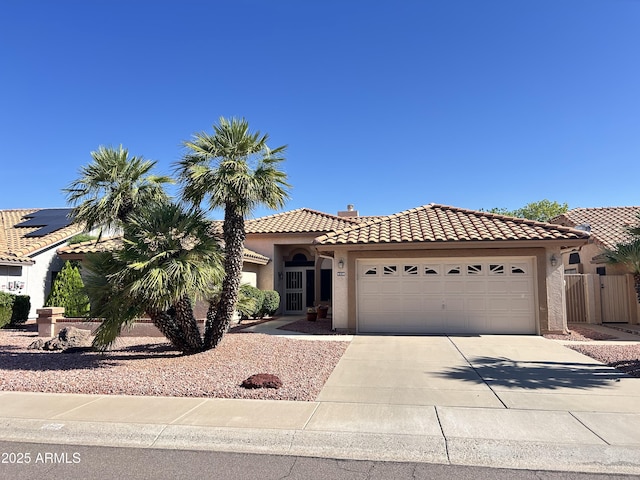 9130 W Utopia Rd, Peoria, AZ 85382 - mediterranean / spanish-style house featuring a tiled roof, a garage, concrete driveway, and stucco siding