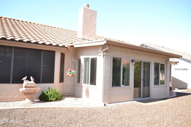 9130 W Utopia Rd, Peoria, AZ 85382 - rear view of house featuring a chimney, stucco siding, and a tiled roof