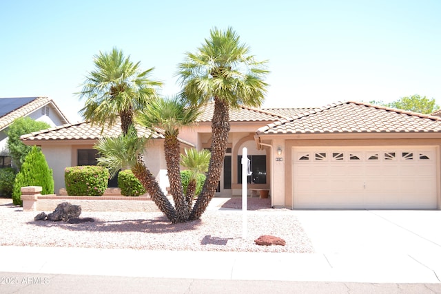 9130 W Utopia Rd, Peoria, AZ 85382 - mediterranean / spanish home featuring stucco siding, a garage, a tiled roof, and driveway