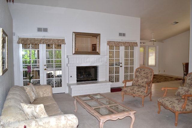9130 W Utopia Rd, Peoria, AZ 85382 - living room featuring french doors, carpet floors, vaulted ceiling, ceiling fan, and a fireplace